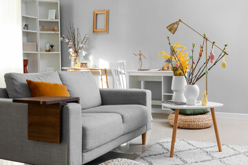 Stylish interior of light living room decorated for Easter celebration