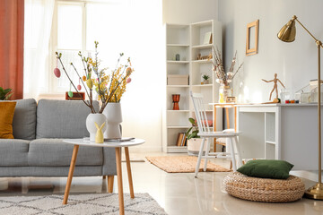 Stylish interior of light living room decorated for Easter celebration