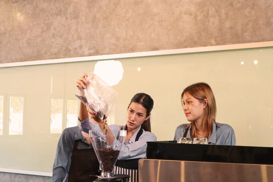 An experienced female barista in uniform will demonstrate how coffee is made and provide a master class. Small business and cafe owner concept 