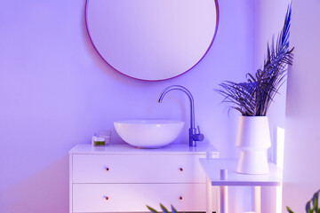 Obraz na płótnie Canvas Interior of stylish bathroom with ceramic sink, mirror and neon lighting