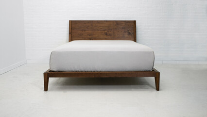 Modern wooden double bed, bed with white bed linen and curtains