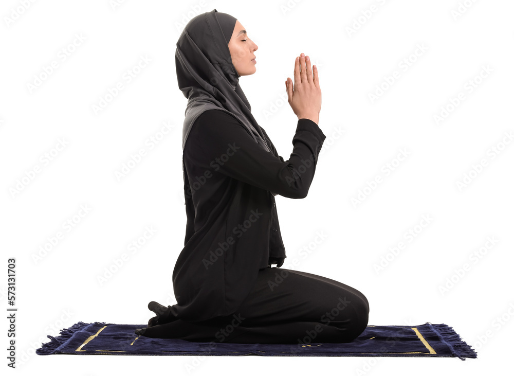 Wall mural Praying Muslim woman on white background