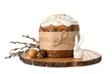 Wooden board with tasty Easter cake, eggs and willow branches on white background