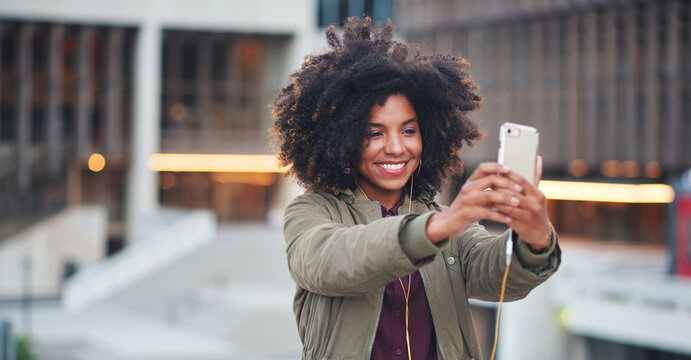 Black woman, city and selfie with afro, phone or smile for social media profile picture. Happy gen z girl, influencer or smartphone for blog, post or networking app on rooftop balcony for travel