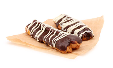 Parchment with sweet chocolate eclairs isolated on white background