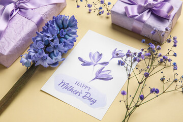 Composition with greeting card, beautiful flowers and gifts for Mother's day celebration on color...