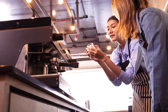 An experienced female barista in uniform will demonstrate how coffee is made and provide a master class. Small business and cafe owner concept 