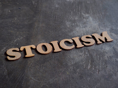 Stoicism word, stoic lifestyle concept, written on wooden lettering