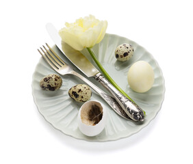 Table serving with Easter eggs and tulip flower isolated on white background