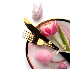 Table serving with Easter eggs, bunny and tulip flower isolated on white background