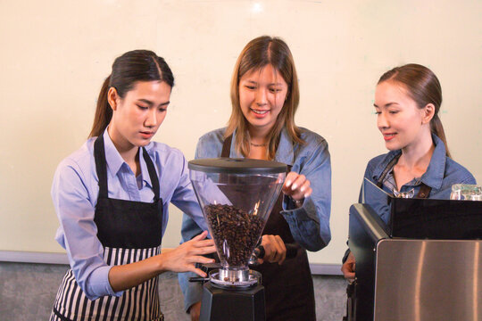 An experienced female barista in uniform will demonstrate how coffee is made and provide a master class. Small business and cafe owner concept 
