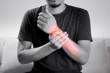 A man hand bone ache, People suffering from pain in wrist on a gray background. Diseases of the elbow joint.