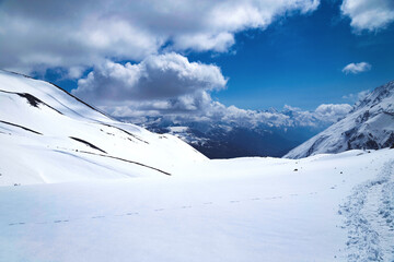 snow covered area against blue sky