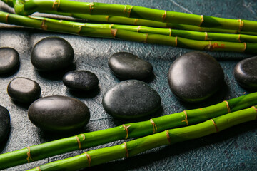 Obraz na płótnie Canvas Spa stones and bamboo on dark background, top view