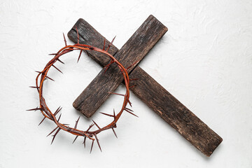 Fototapeta na wymiar Crown of thorns with wooden cross on white background. Good Friday concept
