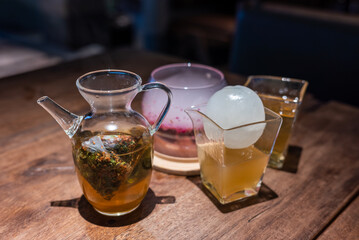 WuLong Ice tea with ice ball on a wooden table - 573139126