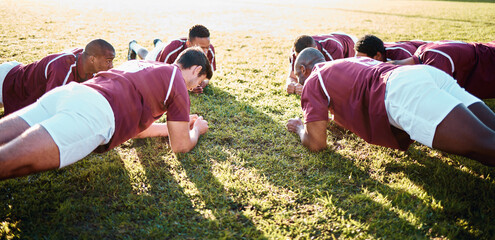 Man, team and plank on grass field for sports training, fitness and collaboration in the outdoors. Group of sport rugby players in warm up exercise together for teamwork preparation, match or game
