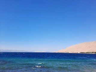 Naklejka premium The mesmerizing view of the deep blue waters of Haql beach in Saudi Arabia. 