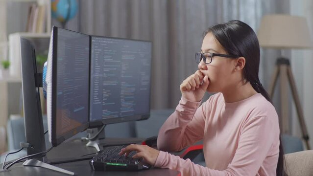 Asian Teen Girl Programmer Yawning While Creating Innovative Software Engineer Developing App, Program, Video Game On Desktop Computer At Home. Terminal With Coding Language 

