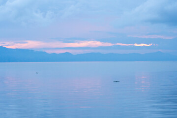 view of the horizon of lake toba in the morning with cloudy weather