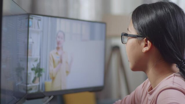 Close Up Of Asian Teen Girl Programmer Learning Online From Teacher On Desktop Computer While Creating Software Engineer Developing App, Program, Video Game At Home. Terminal With Coding Language 
