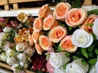 Colorful artificial flower made from plastic and fabric being displayed in accessories store.