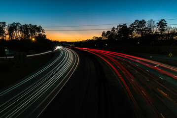 Heavy traffic on a highway  at the blue hour. Cars leaving light trails on a highway. at the blue hour.