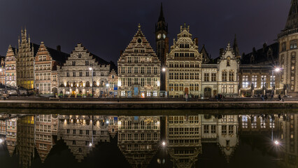 Fototapeta na wymiar Cityscape at night and water reflection in Gent, Belgium in January 2023