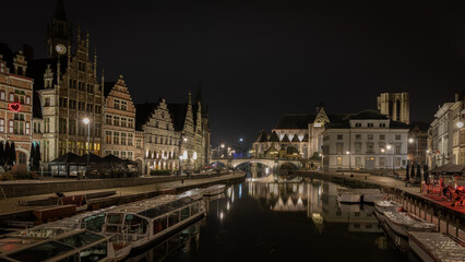 Fototapeta na wymiar Cityscape at night and water reflection in Gent, Belgium in January 2023