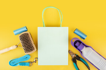 goods for pets, dog and cat accessories on a yellow background, copy space, top view, flat lay