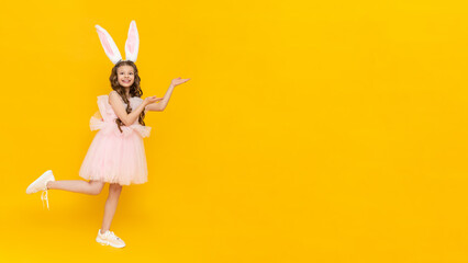 Festive Easter. A teenage girl in a fluffy dress and with rabbit ears points to your advertisement...