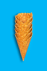 Lot Ice cream cones isolated on blue background. Food.