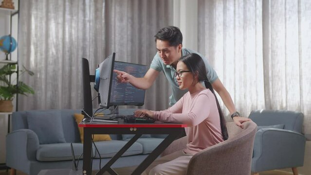 Asian Teen Girl Students Studying Software Code From Male Teacher Or Father
