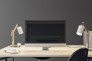Front view on blank black modern computer monitor screen with place for your logo or text on wooden work table with lamps on grey wall background. 3D rendering, mockup