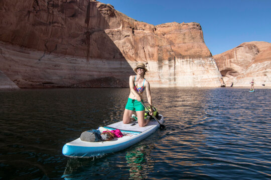 Woman paddleboarding&Acirc;&nbsp;in Lake Powell, Utah, USA