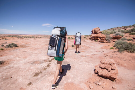 Two women hiking in desert, Grand Staircase-Escalante National Monument, Utah, USA