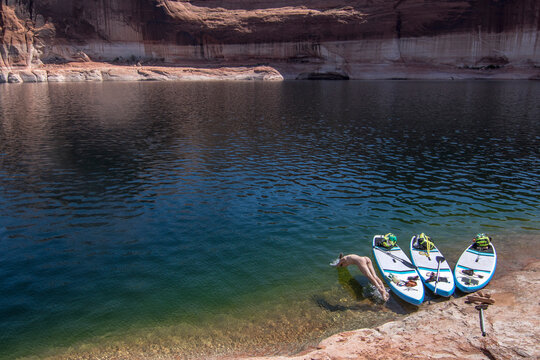 Woman jumping into lake, Utah, USA