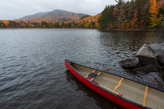 A canoe on the shore of Greenough Pond in Wentworths Location, New Hampshire. Fall. Northern Forest.