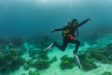 Female scuba diver striking a pose in Komodo