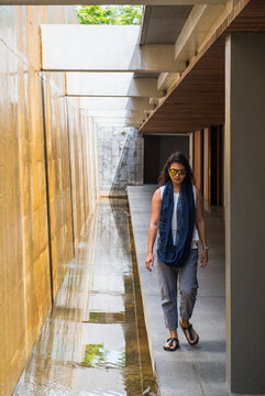 Woman walking next to artificial waterfall, Chiang Mai, Thailand