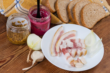 Slices of salted pork fatback, brown bread and seasonings
