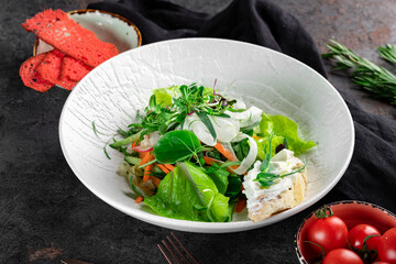 Fresh diet green salad of raw vegetables on a white plate. Vegan Leaf Salad