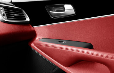 Car door handle inside the luxury modern car with red leather interior. Switch button control....