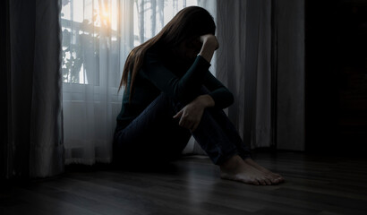 Sad young woman sitting on the bed in the bedroom, People with depression concept.	 - obrazy, fototapety, plakaty