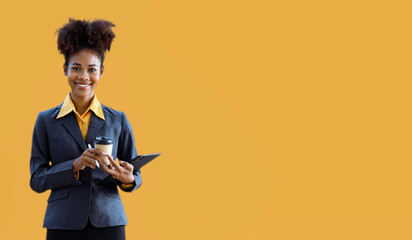 person writing on clipboard, African American businesswoman standing on yellow background.