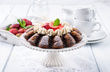 Traditional German strawberry cheese cake with fresh fruits and white chocolate cream served as close-up on a cake plate