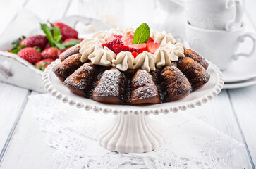 Traditional German strawberry cheese cake with fresh fruits and white chocolate cream served as close-up on a cake plate