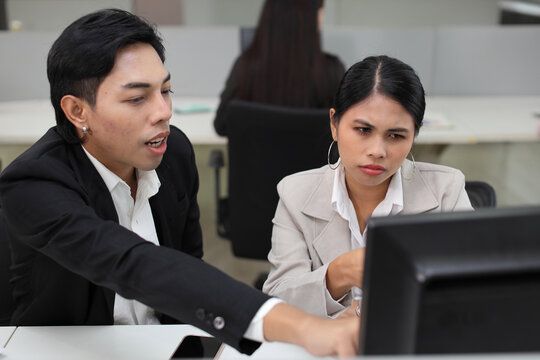 Business people gossiper group whispering or sharing rumor about their colleague in the office. Male coworker sitting and telling gossip to female workmate about bullying problem at work place.