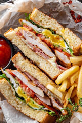 Club sandwich with French fries and sauce