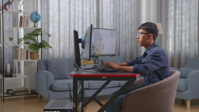 Asian Boy Programmer Learning Online From Teacher On Desktop Computer While Creating Software Engineer Developing App, Program, Video Game At Home. Terminal With Coding Language 
